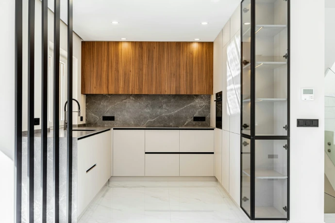 Modern white and wood kitchen with marble backsplash