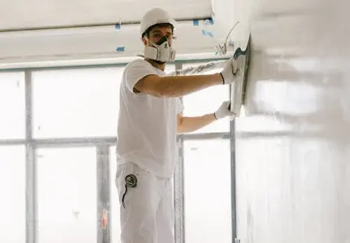 Drywall interior painting A freshly hung drywall surface being painted