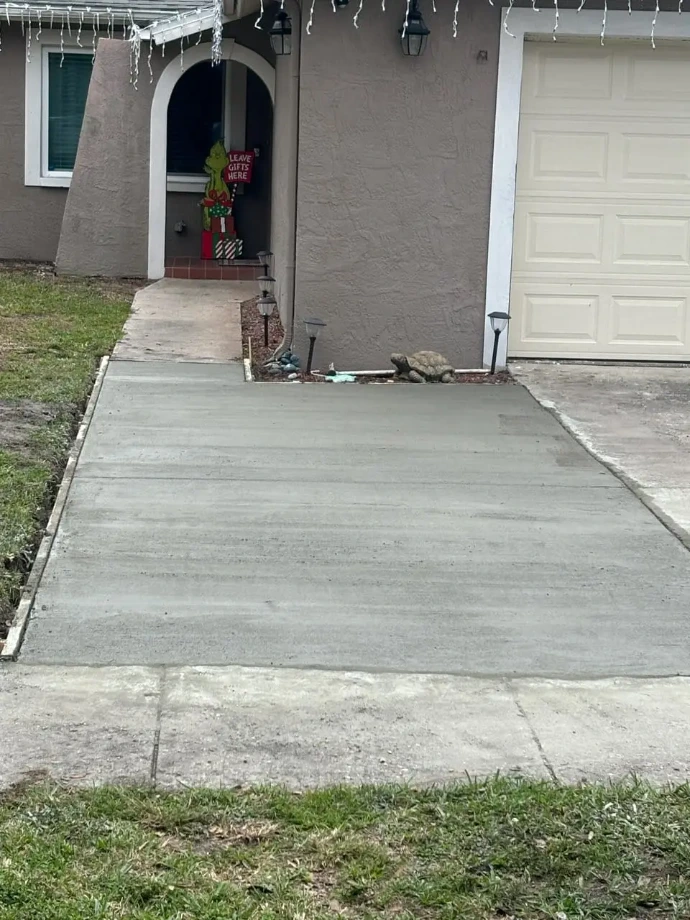 a freshly poured concrete driveway extension
