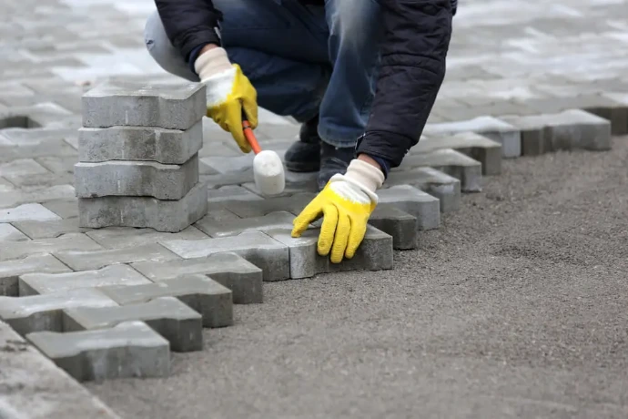 paver laying done by worker