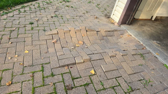 sinking paver area likely indicates a failure of the sub-base or soil underneath